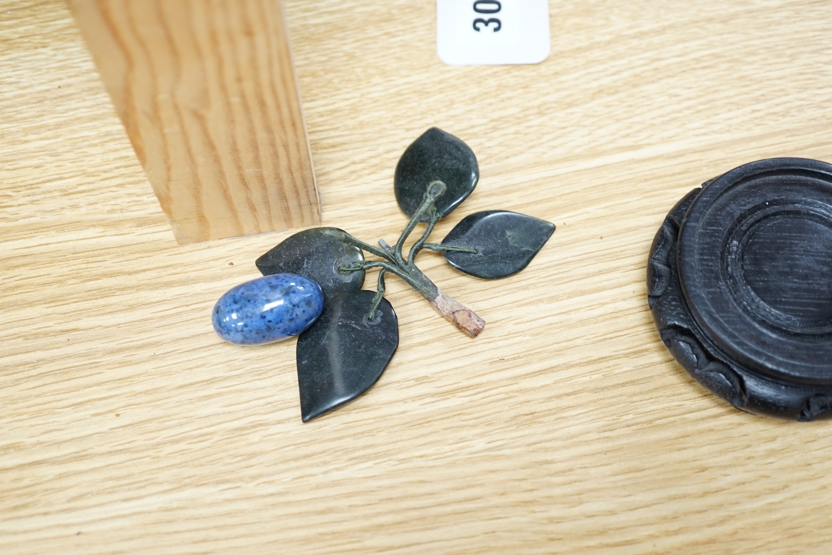Five polished hardstone and soapstone bunches of grapes and six glazed china fruits, banana 19cm long (11)
